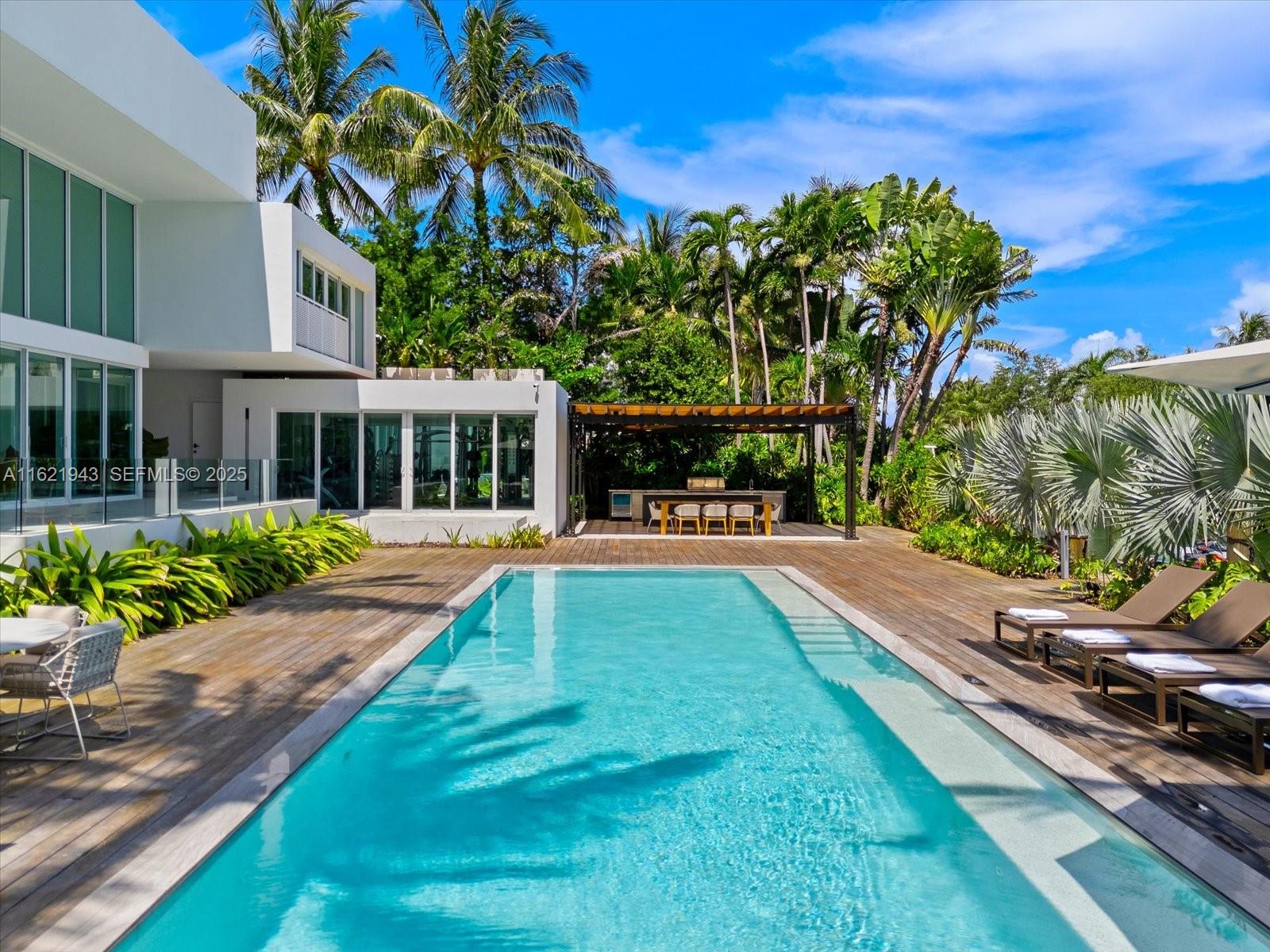 161 Cape Florida Drive Key Biscayne, FL 33149 - Photo 8 of 49 a view of a house with swimming pool and sitting area