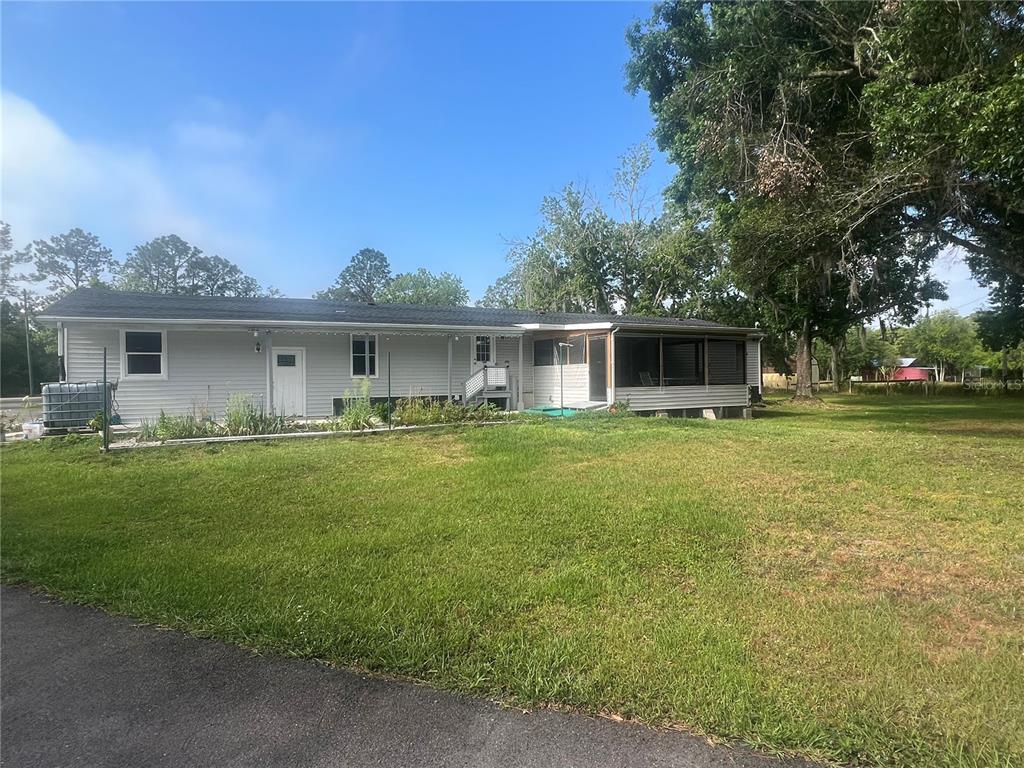 5855 Jack Brack Road St. Cloud, FL 34771 - Photo 2 of 86 a front view of house with yard and green space
