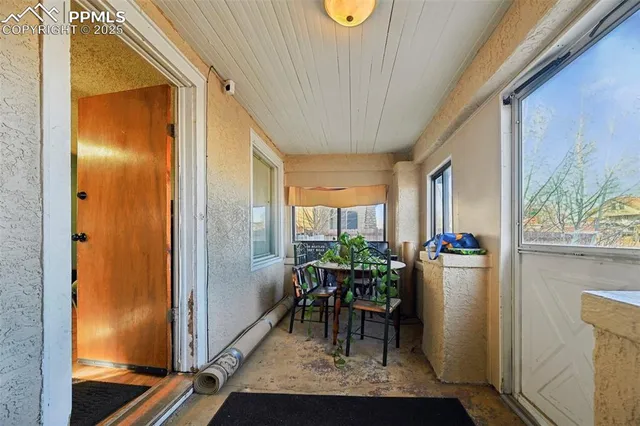 a dining room with furniture and a potted plant