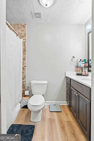 a bathroom with a sink toilet and a mirror