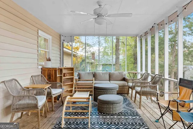 a living room with patio chairs and a large window