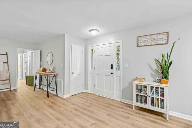 a bedroom with furniture and wooden floor