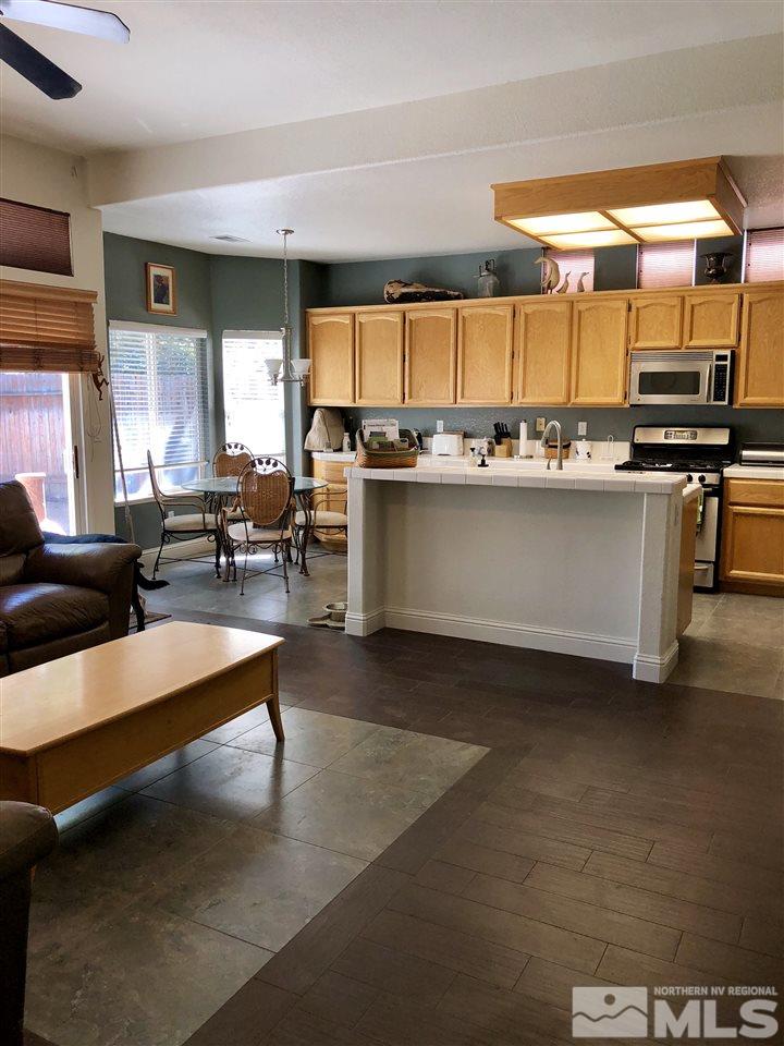 9440 Oakley Lane Reno, NV 89521 - Photo 13 of 25 a large living room with stainless steel appliances granite countertop furniture and a view of kitchen