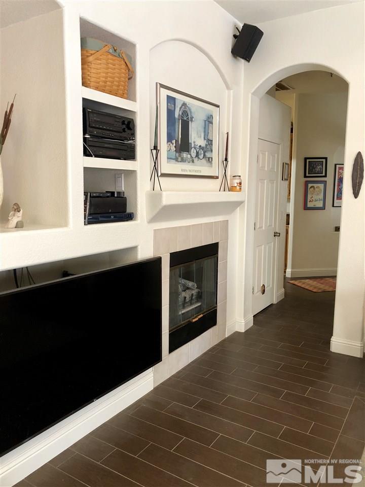 9440 Oakley Lane Reno, NV 89521 - Photo 15 of 25 a view of an empty room with a fireplace and a window