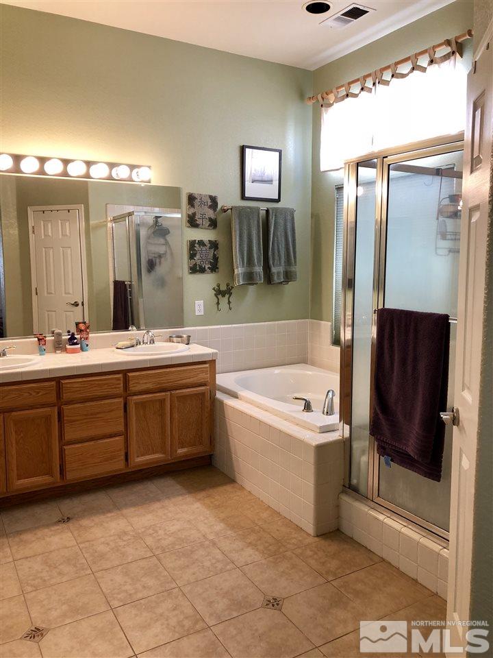 9440 Oakley Lane Reno, NV 89521 - Photo 19 of 25 a spacious bathroom with a tub sink and mirror