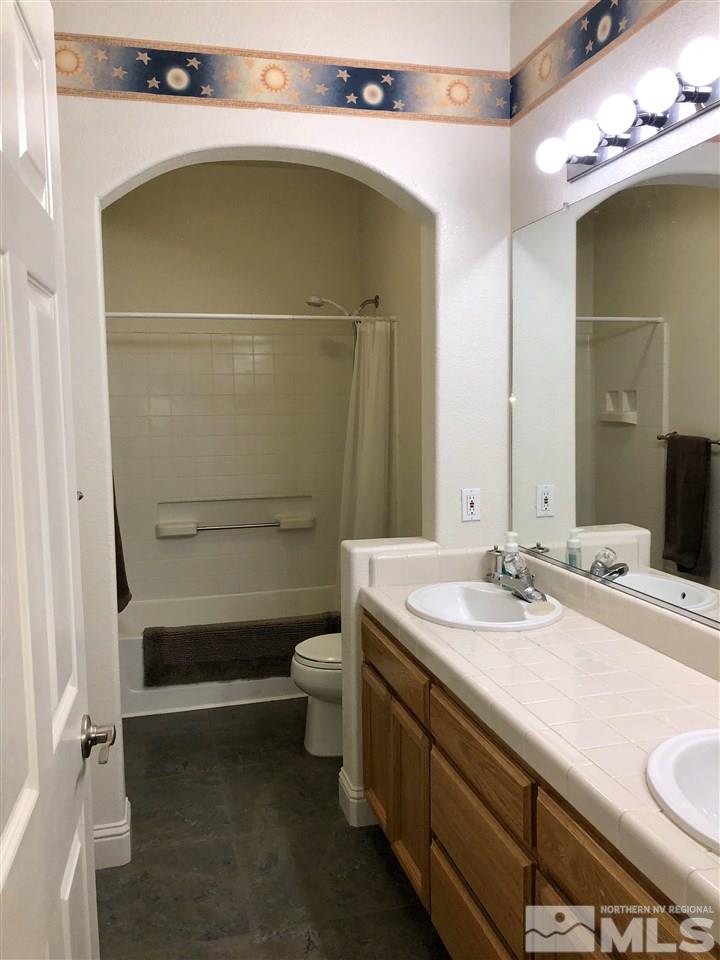 9440 Oakley Lane Reno, NV 89521 - Photo 21 of 25 a bathroom with a sink a toilet and shower
