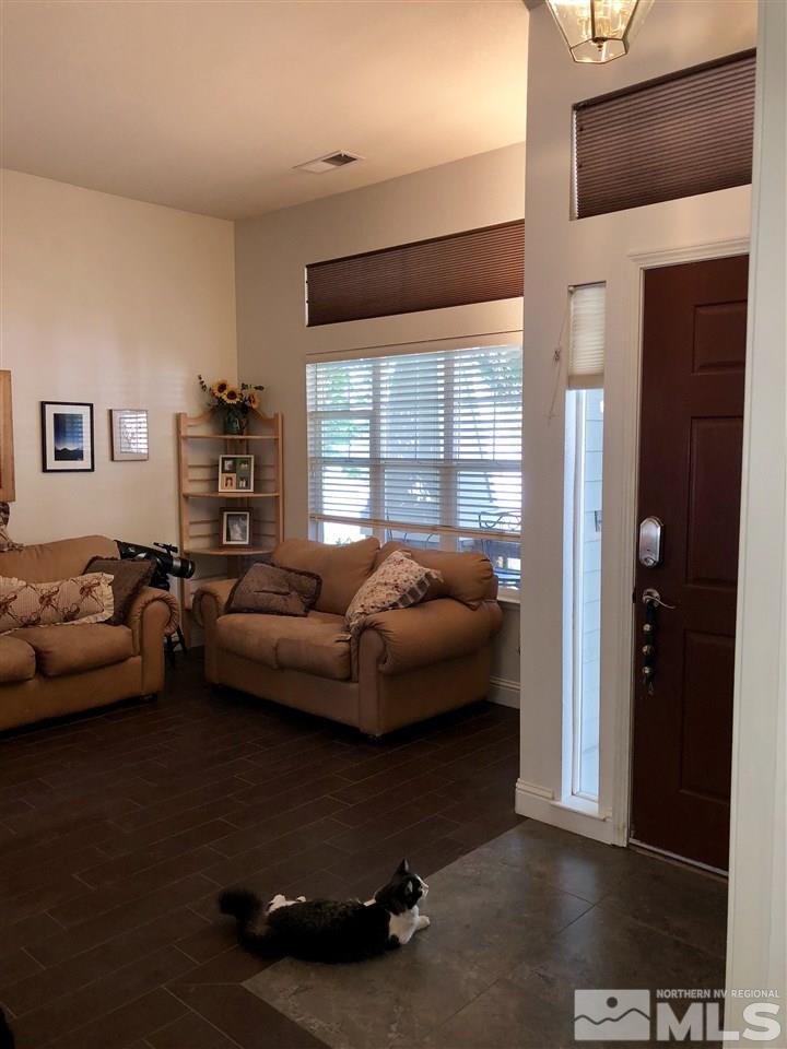 9440 Oakley Lane Reno, NV 89521 - Photo 6 of 25 a living room with furniture and a flat screen tv