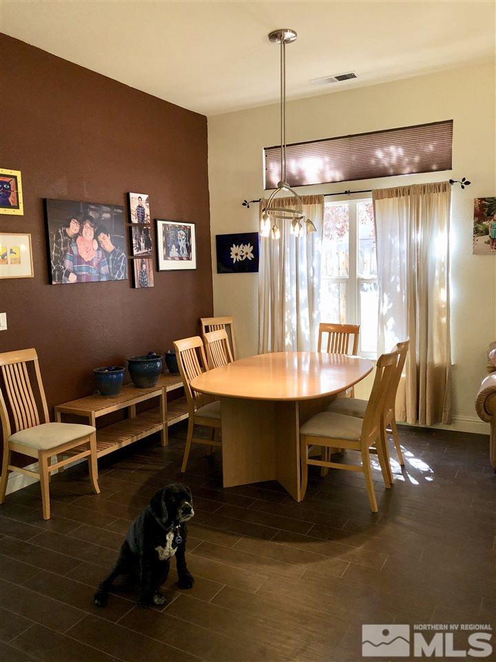 9440 Oakley Lane Reno, NV 89521 - Photo 7 of 25 a view of a dining room with furniture window and wooden floor