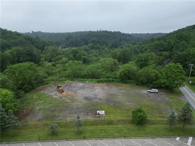 an aerial view of a house with yard