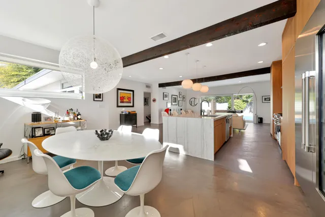 a dining room with furniture and a chandelier