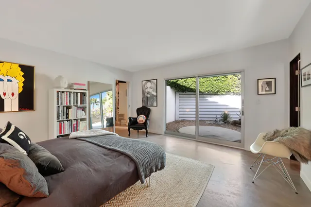 a bedroom with a bed and a couch