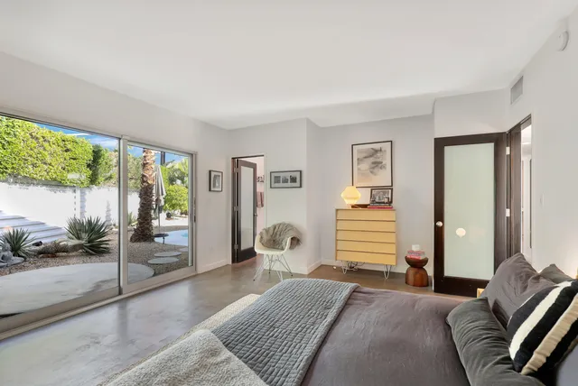 a bedroom with furniture and a window