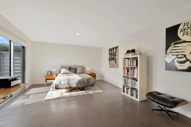a bed room with a bed and a book shelf