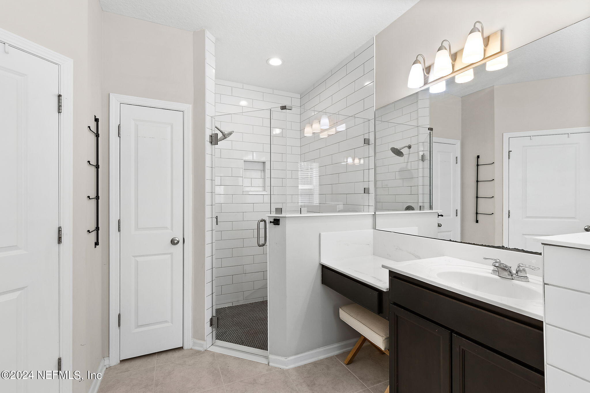 612 Watervale Drive St. Augustine, FL 32092 - Photo 15 of 28 a large bathroom with a double vanity sink a mirror and a shower