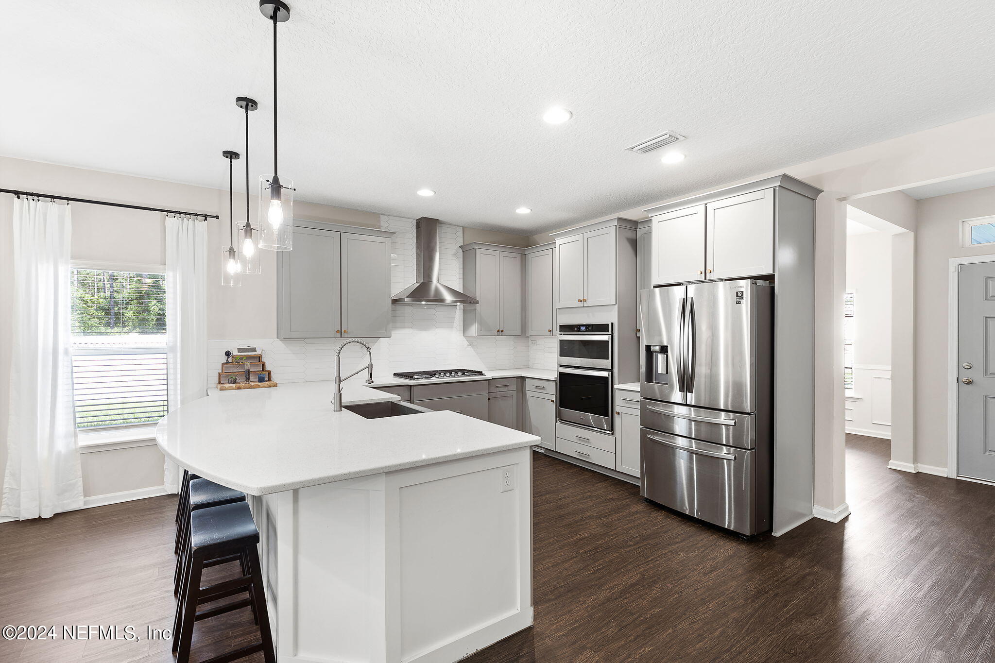 612 Watervale Drive St. Augustine, FL 32092 - Photo 7 of 28 a kitchen with refrigerator cabinets and wooden floor