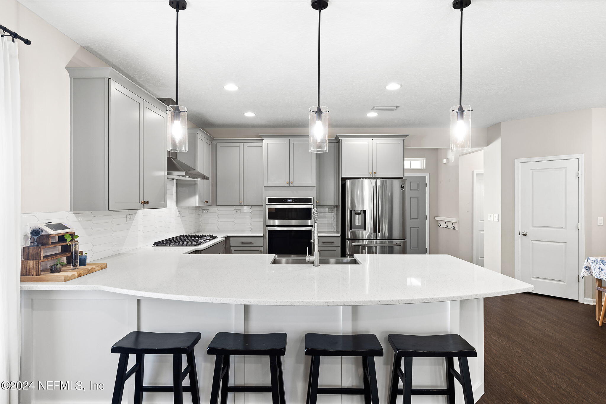 612 Watervale Drive St. Augustine, FL 32092 - Photo 8 of 28 a kitchen with kitchen island a dining table chairs stainless steel appliances and cabinets
