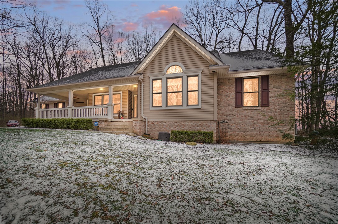 5300 Brookshire Lane Springfield, OH 45502 - Photo 1 of 56 This charming home features a welcoming porch, nestled amidst mature trees, offering a tranquil retreat.