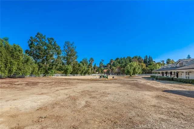 a view of a field and trees