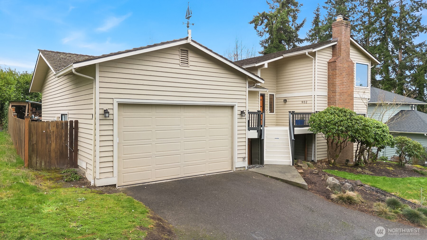 a view of a house with a yard and garage