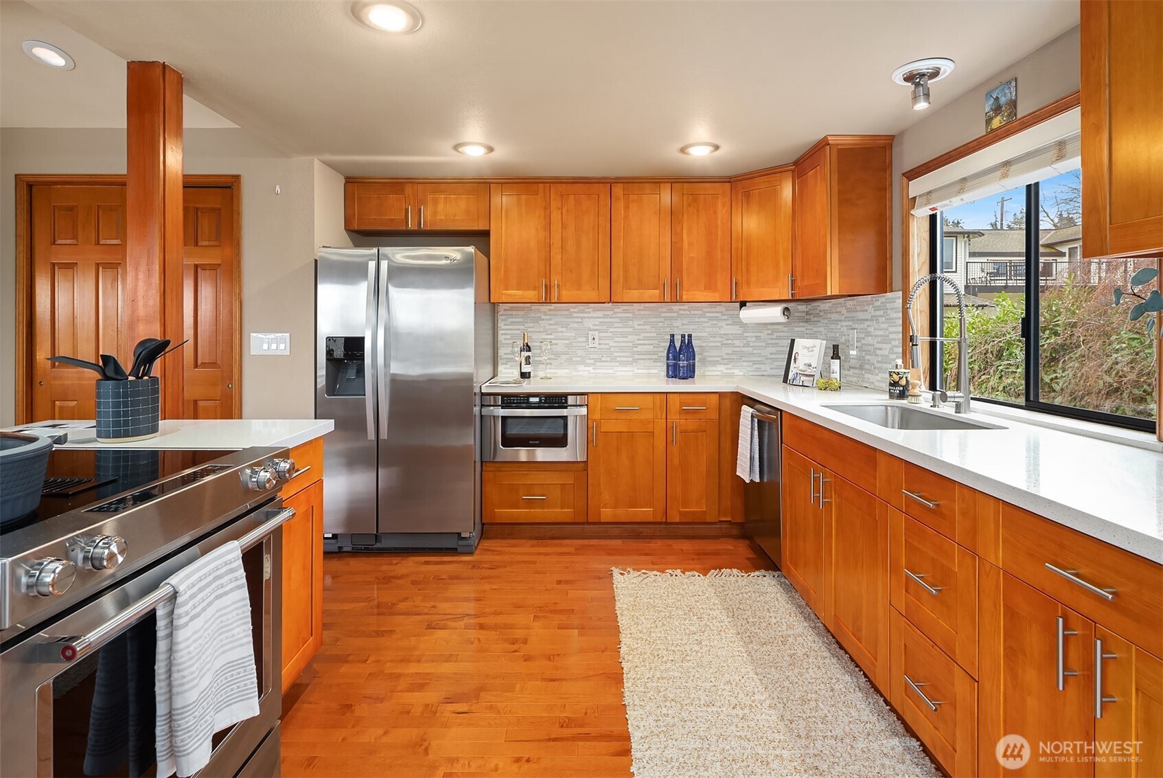 902 7th Avenue South Edmonds, WA 98020 - Photo 12 of 34 a kitchen with stainless steel appliances granite countertop a sink a stove and a refrigerator