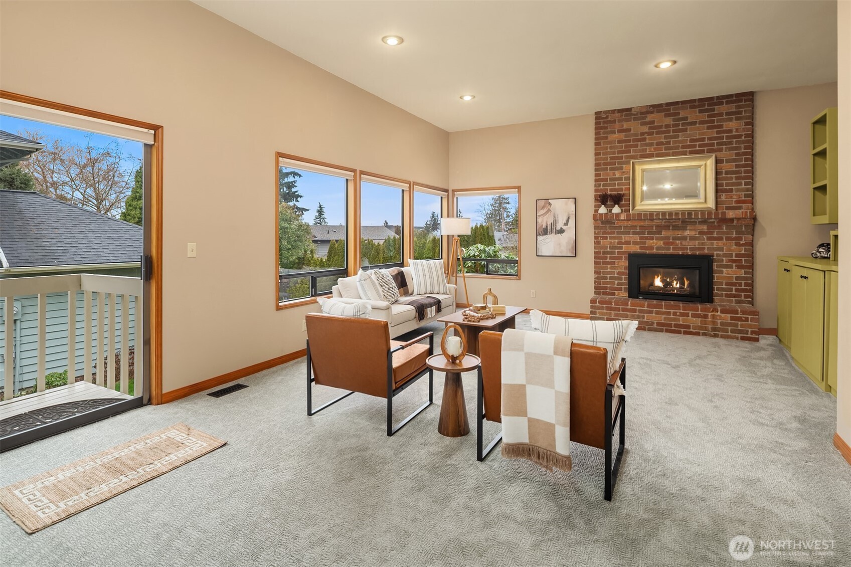 902 7th Avenue South Edmonds, WA 98020 - Photo 19 of 34 a living room with furniture a fireplace and a floor to ceiling window