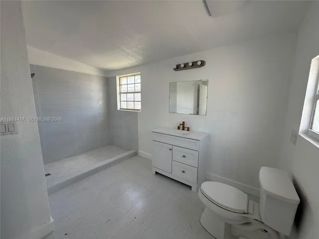 a bathroom with a toilet sink and shower