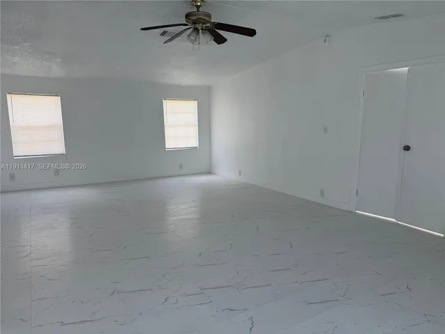 an empty room with a empty space and a window