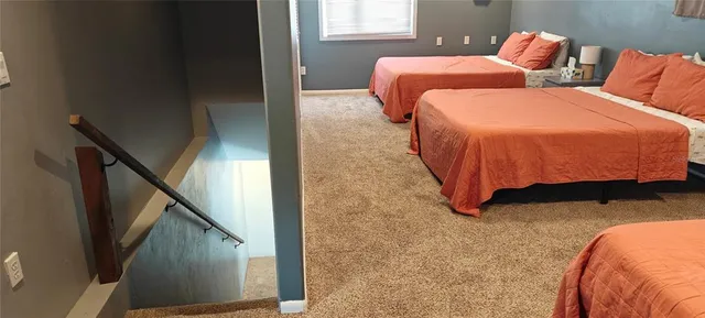 a bed sitting in a bedroom next to a lamp