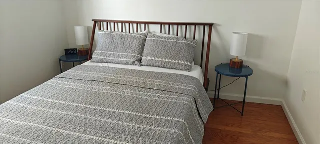 a bed room with a bed and a chair