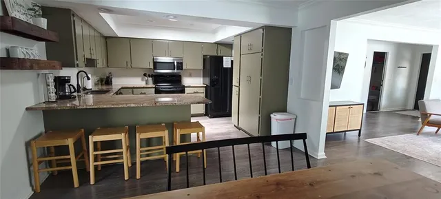 a kitchen with a refrigerator sink and stove top oven