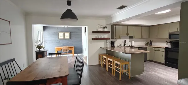 a hallway with wooden floor and a fireplace