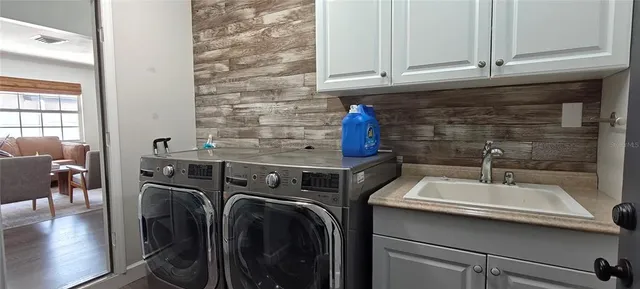 a living room with furniture and a refrigerator