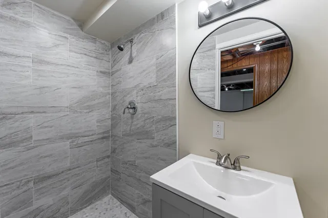 a bathroom with a sink toilet and mirror