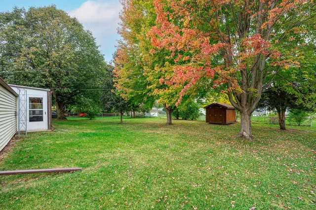a view of a house with backyard and sitting area