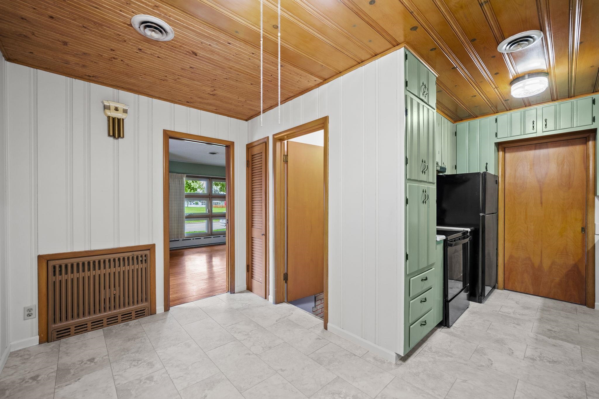 1205 7th Avenue Belvidere, IL 61008 - Photo 6 of 33 a view of a hallway with wooden walls and door