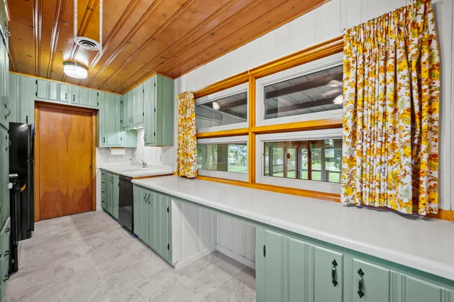 a kitchen with stainless steel appliances granite countertop a sink and cabinets