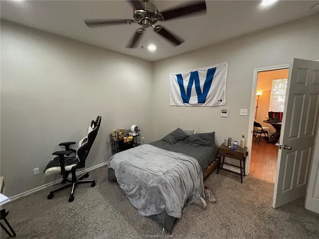 a bathroom with a toilet and a shower curtain
