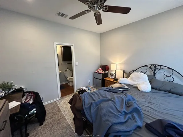 a view of a livingroom with workspace and a window