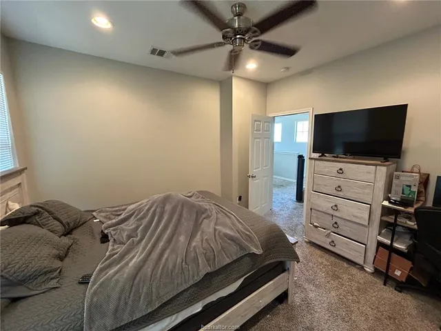 a bedroom with bed and a chandelier