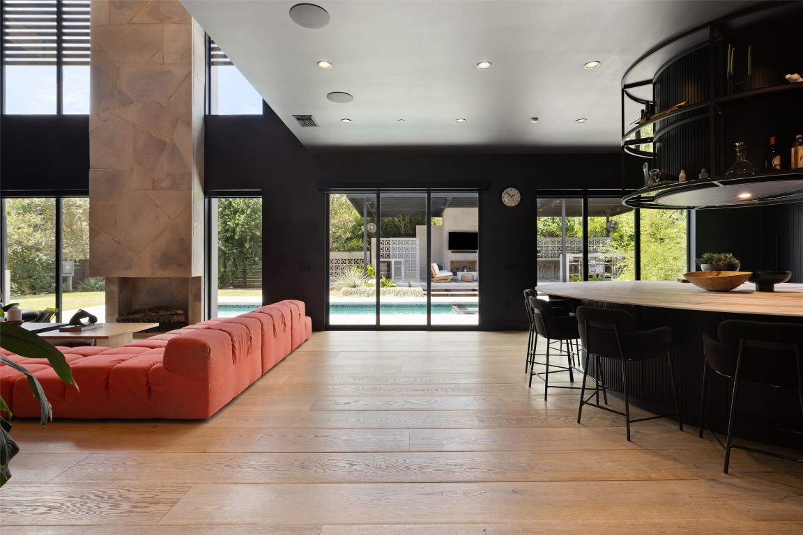 a living room with furniture and large windows