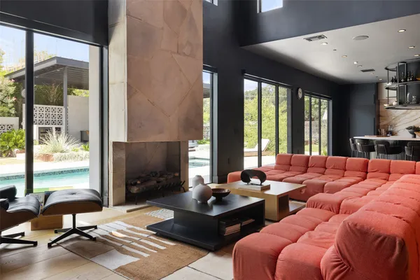 a outdoor kitchen with furniture and a flat screen tv