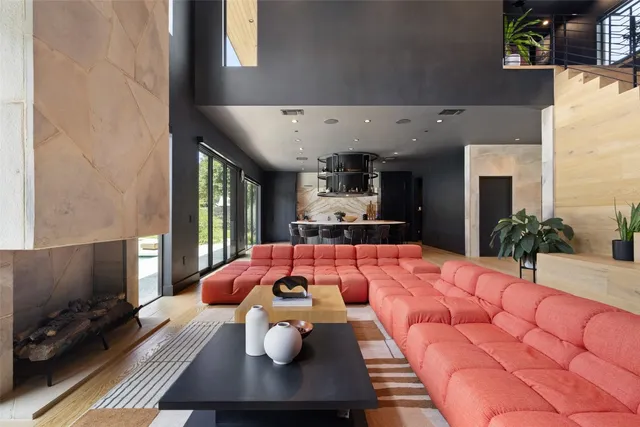 a living room with furniture and a floor to ceiling window