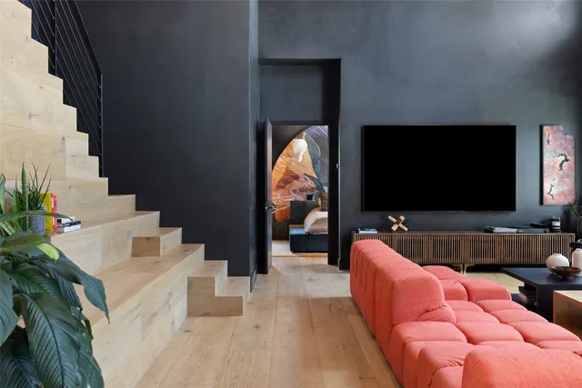 a bed sitting in a room next to a large window