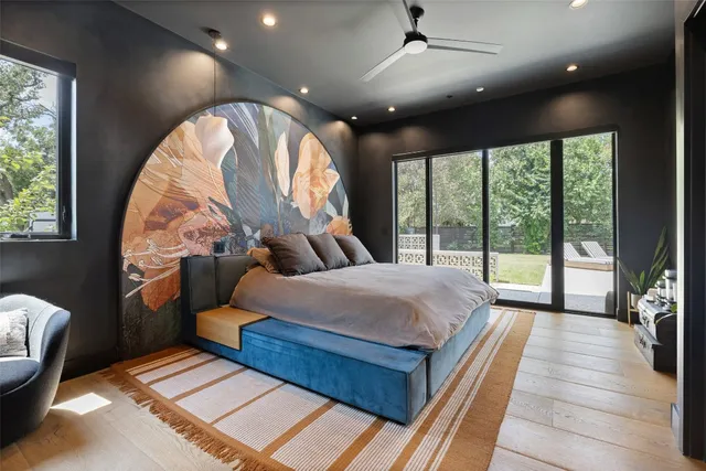 a bedroom with a bed and a large window