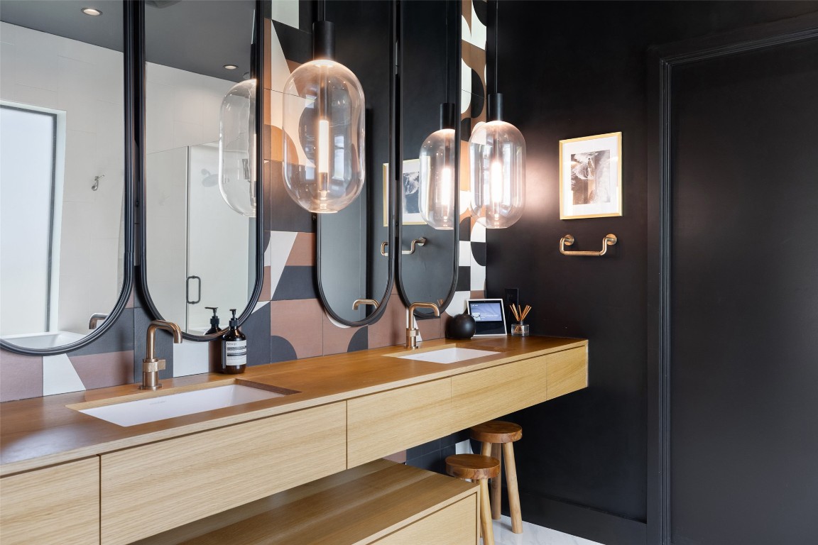 204 Westbrook Drive Austin, TX 78746 - Photo 18 of 40 a bathroom with double vanity sinks and a mirror