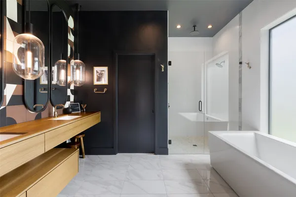 a bathroom with double vanity sinks and a mirror