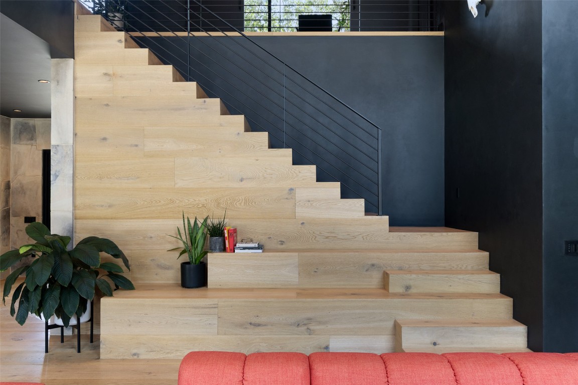 204 Westbrook Drive Austin, TX 78746 - Photo 23 of 40 a view of staircase with white walls and potted plants