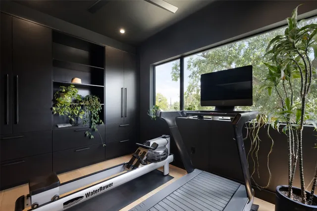 a bedroom with a bed and glass window