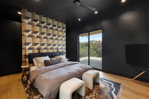 a bedroom with a large window and a bed