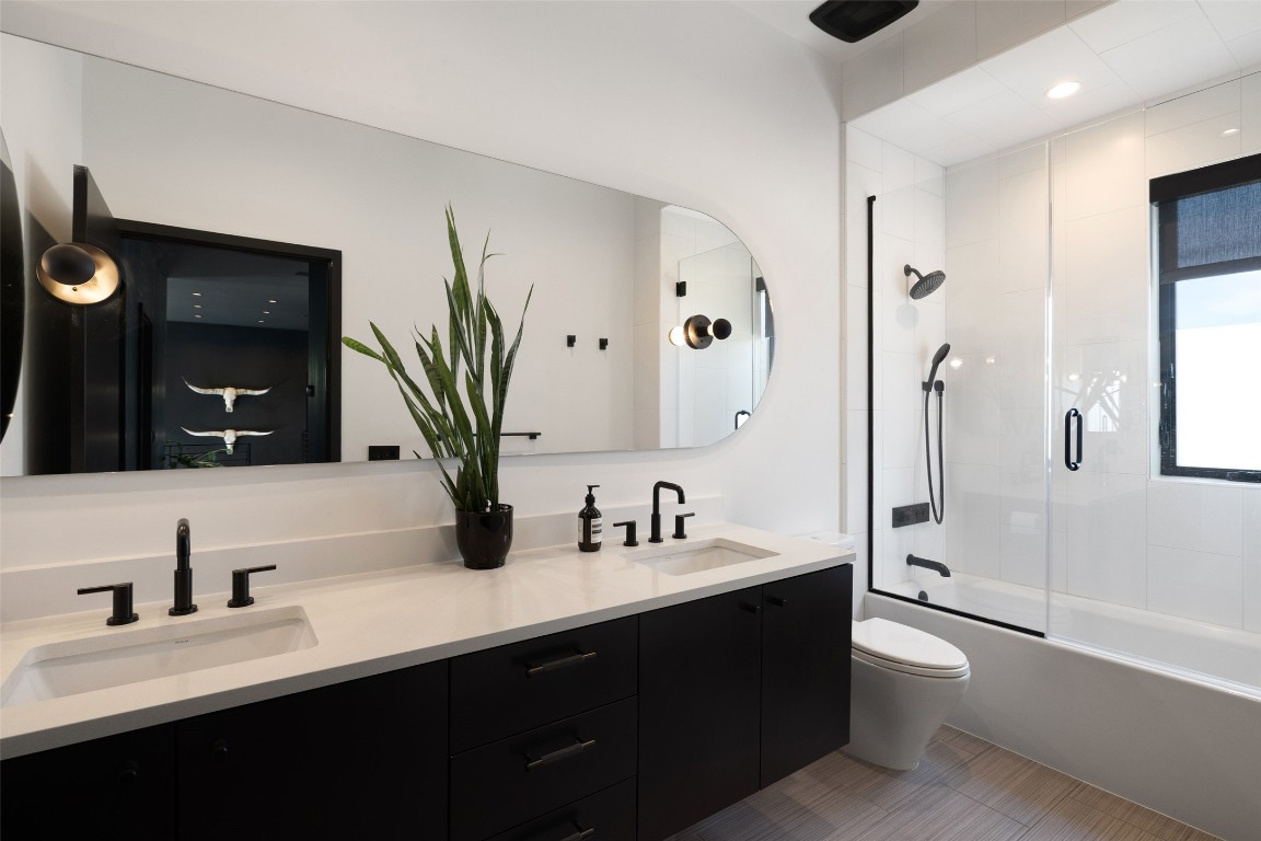 204 Westbrook Drive Austin, TX 78746 - Photo 31 of 40 a bathroom with a double vanity sink toilet mirror and bathtub